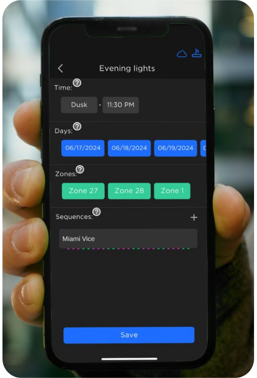 A hand holds a smartphone displaying an app screen with settings for "Evening lights," including time, days, zones, and sequences.